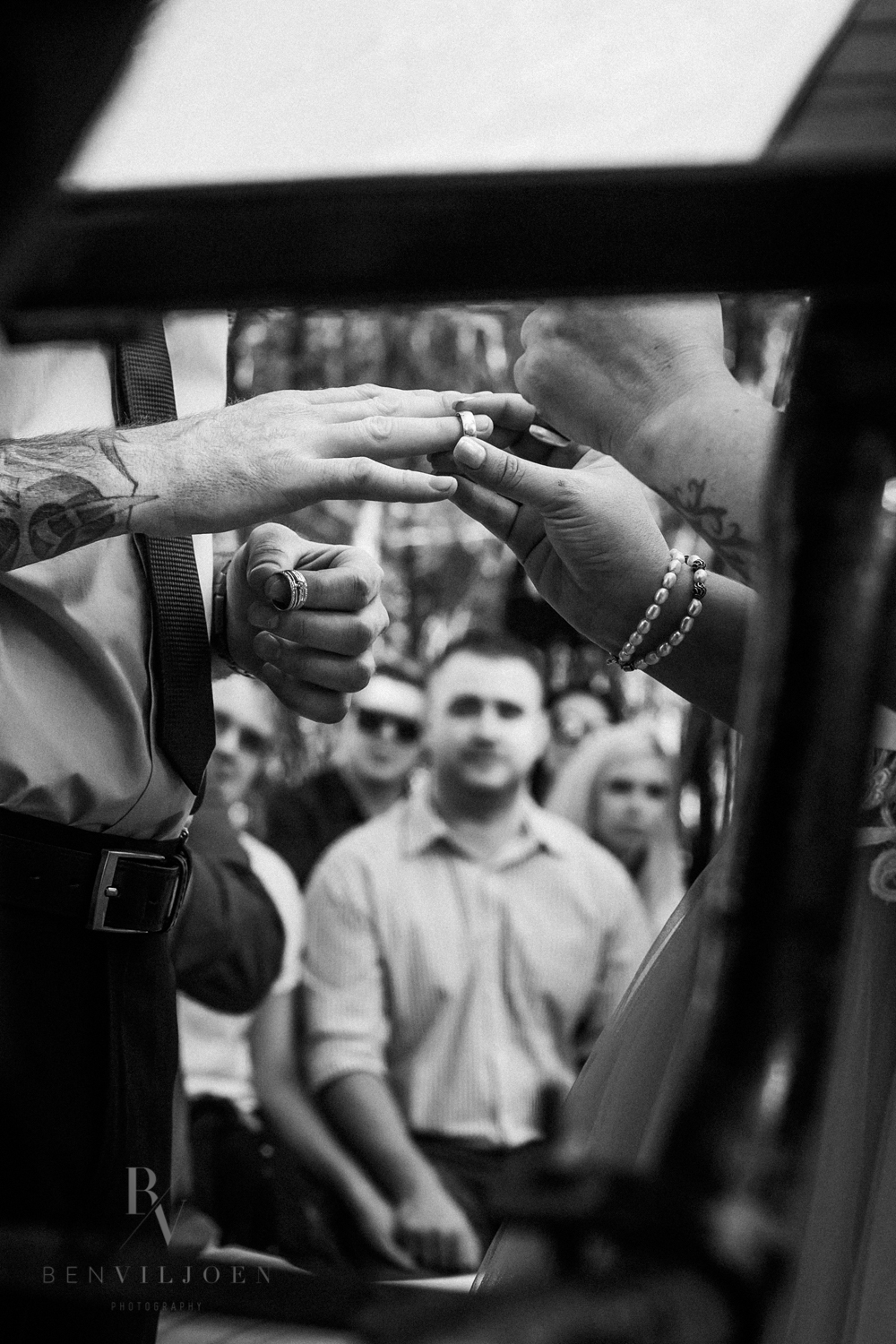 The moment before ‘I do’ Bride sliding wedding ring onto groom’s finger - emotional black and white Pretoria wedding photo