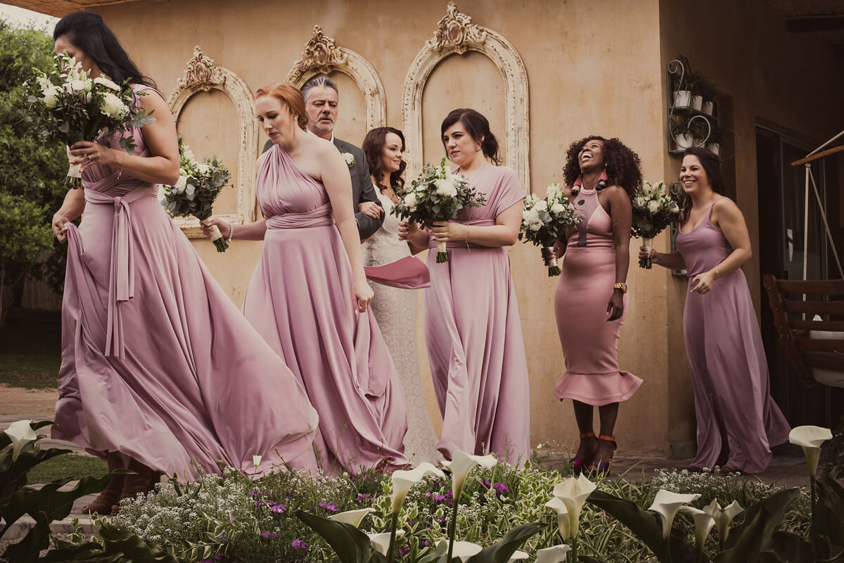 bridesmaids and father of the bride outside bridal suite on their way to the wedding ceremony at Cradle Valley Muldersdrift