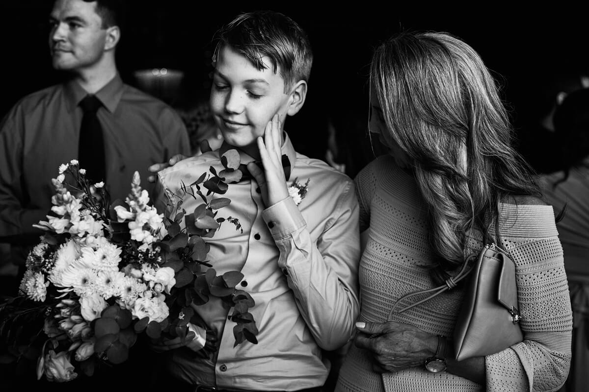 Page boy having a moment with the mother of the bride at a wedding