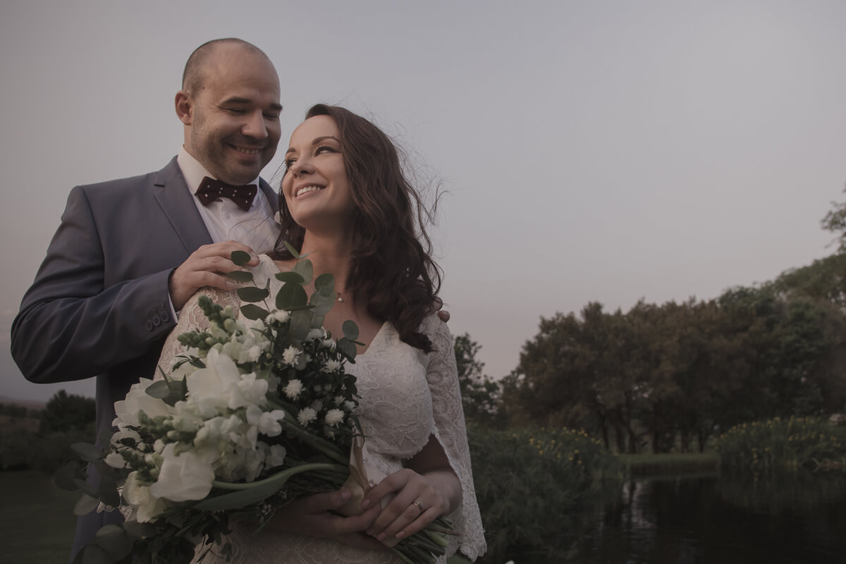 Bride and groom sharing a relaxed, happy moment at Cradle Valley Guest House during the blue hour, with soft ambient light creating a romantic atmosphere.
