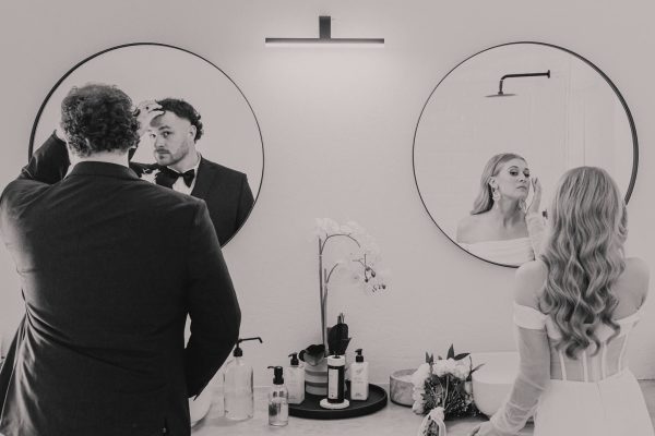 Bride and groom touch ups in bathroom before the reception. Bell & Blossom, Pretoria