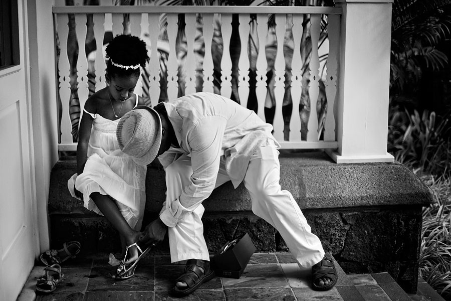 Groomsman helping flowergirl with her shoes