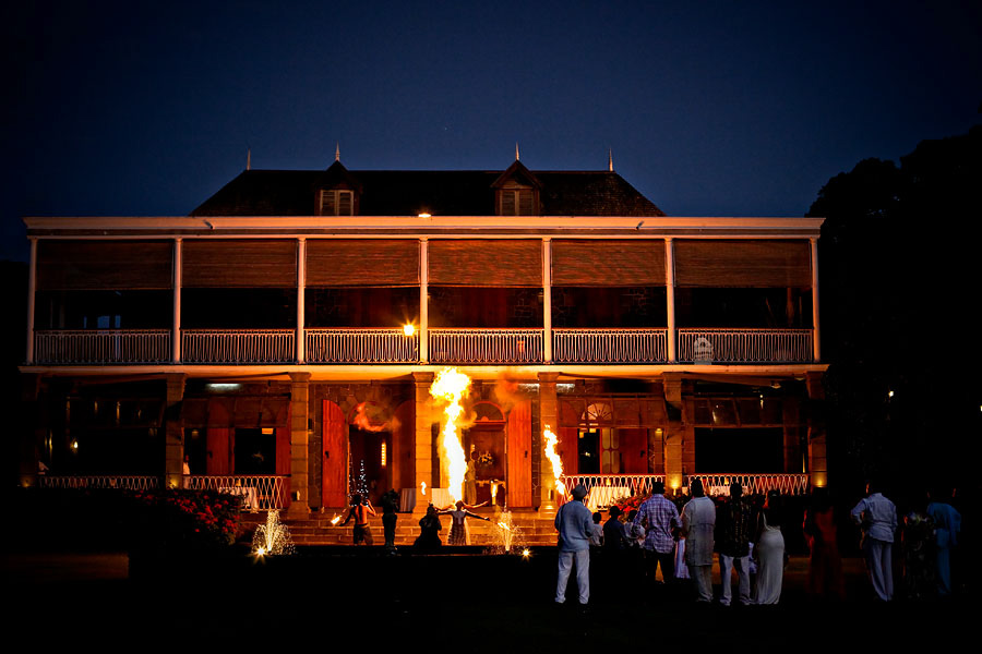 Fire blowers entertaining wedding guests outside chateau in Mauritius